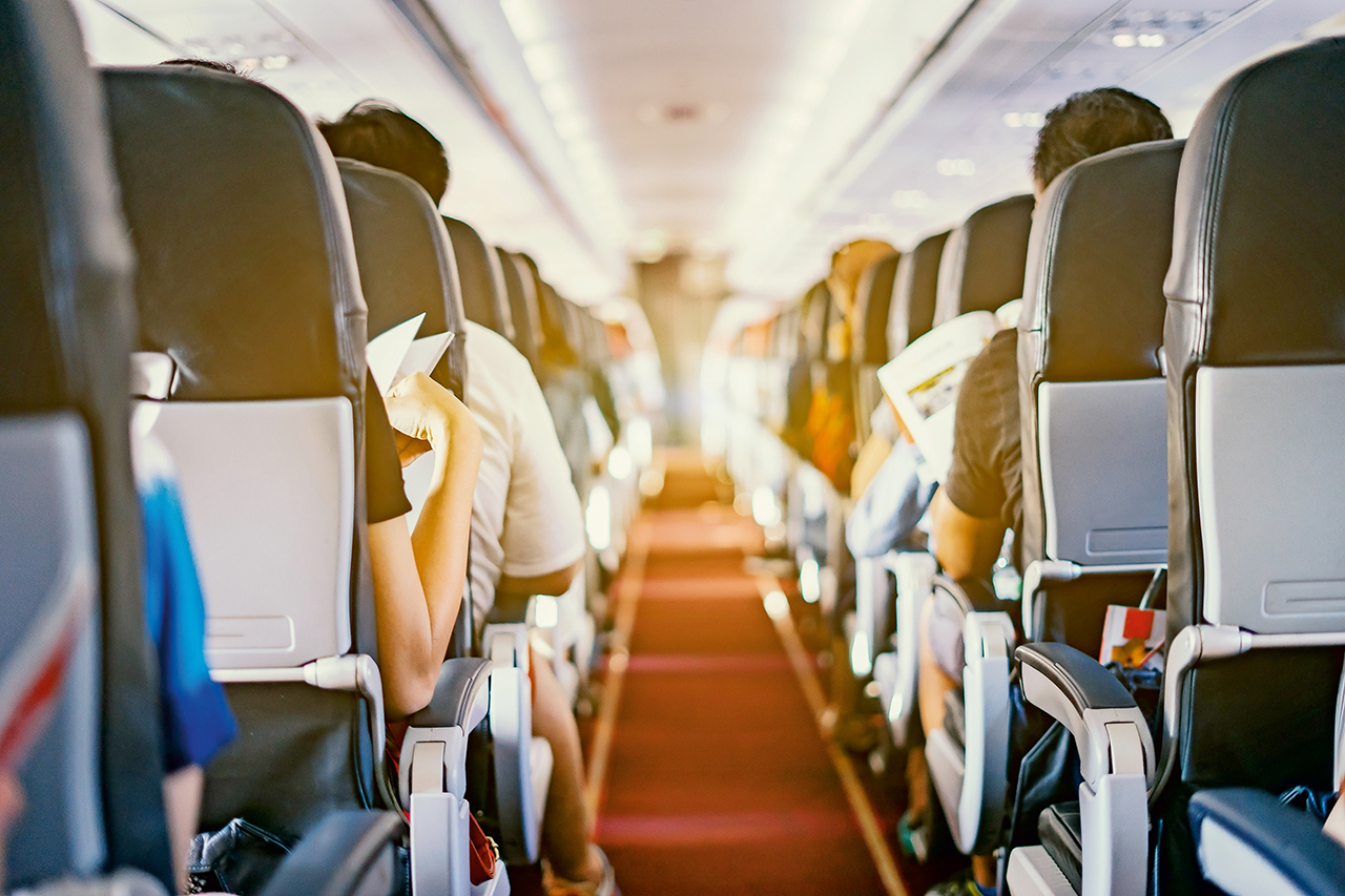 passenger seat, Interior of airplane with passengers sitting on
